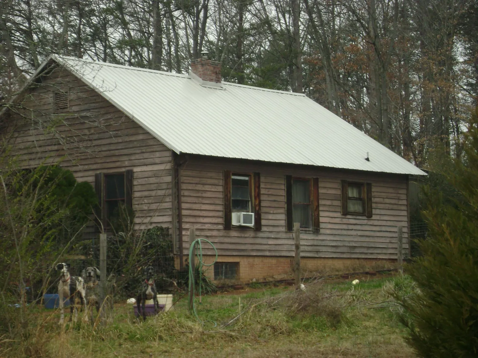 White metal roof on an old wood sided farmhouse, from a Metal Roof Installation job in Cataldo